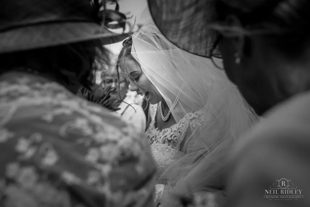 Black and white image of bride and her guests outside St Thomas Church in St Annes-on-Sea