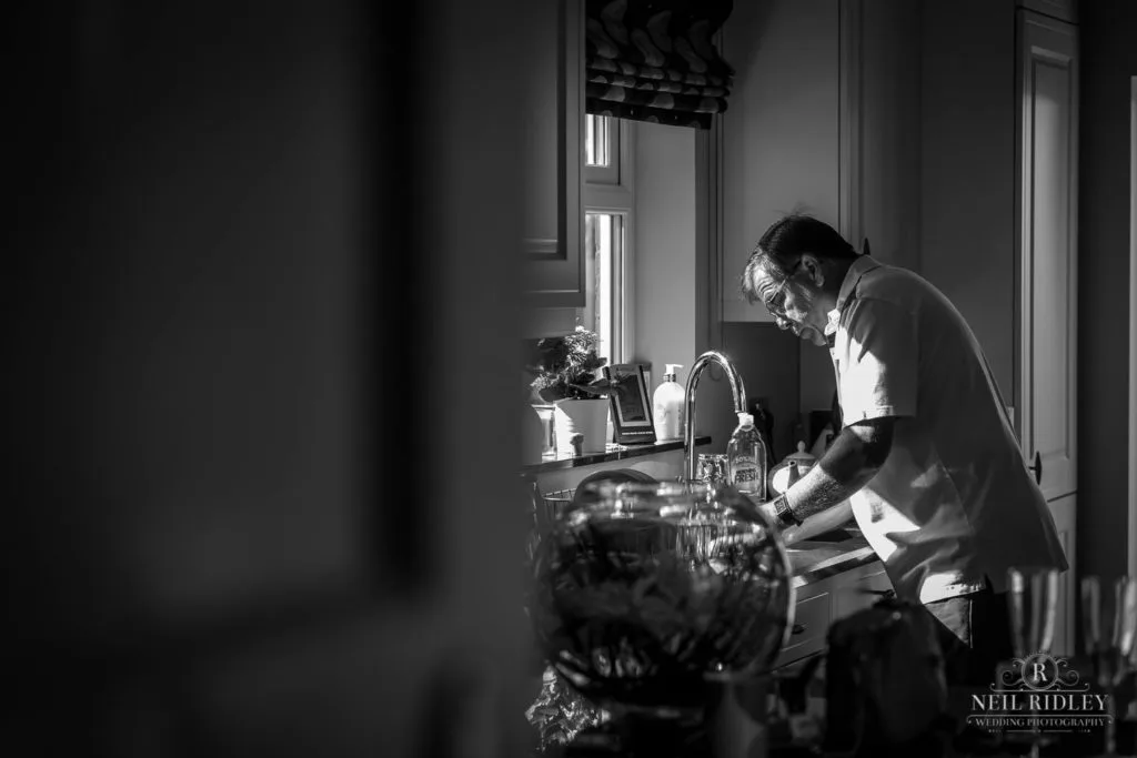 Black and white image of Father washing up during Bridal Prep