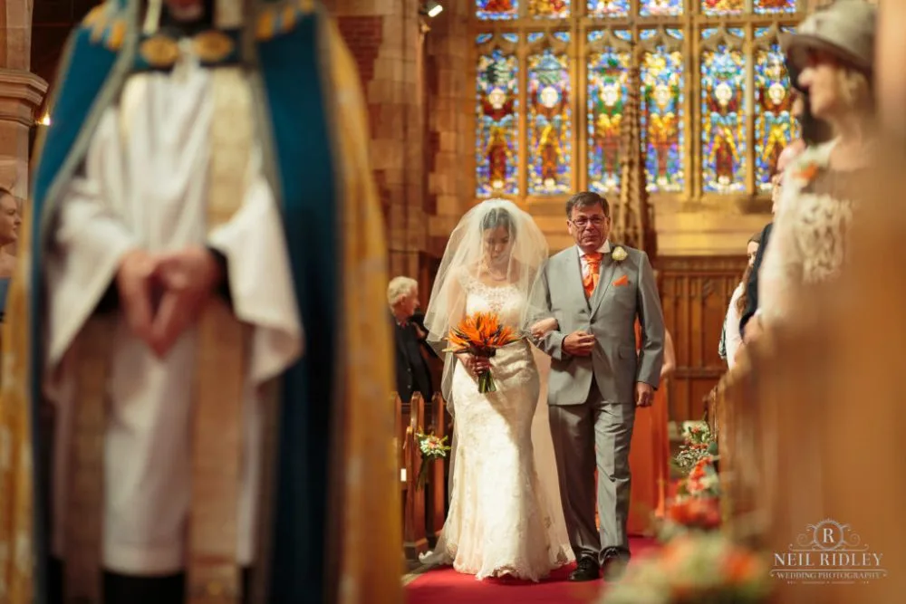 Bride walks down the aisle with her F her father is crying at St Thomas Church in St Annes-on-Sea