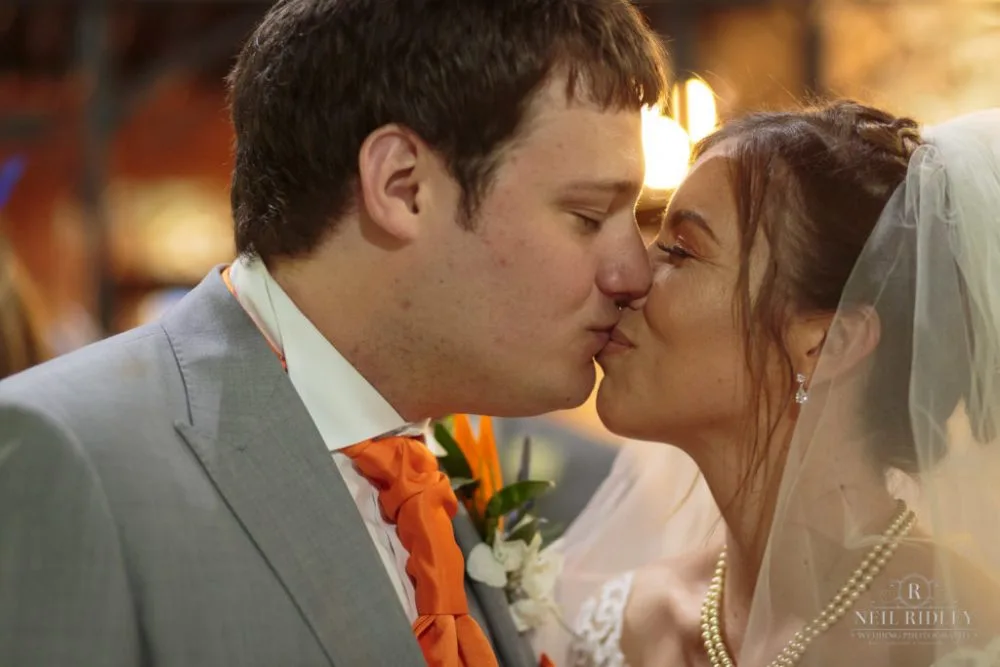 Bride and Groom Kiss at Altar in St Thomas Church in St Annes-on-Sea