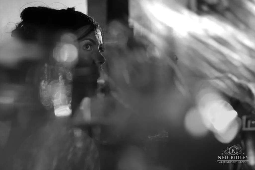 Black and white image of bride listening to speeches at The Great Hall at Mains