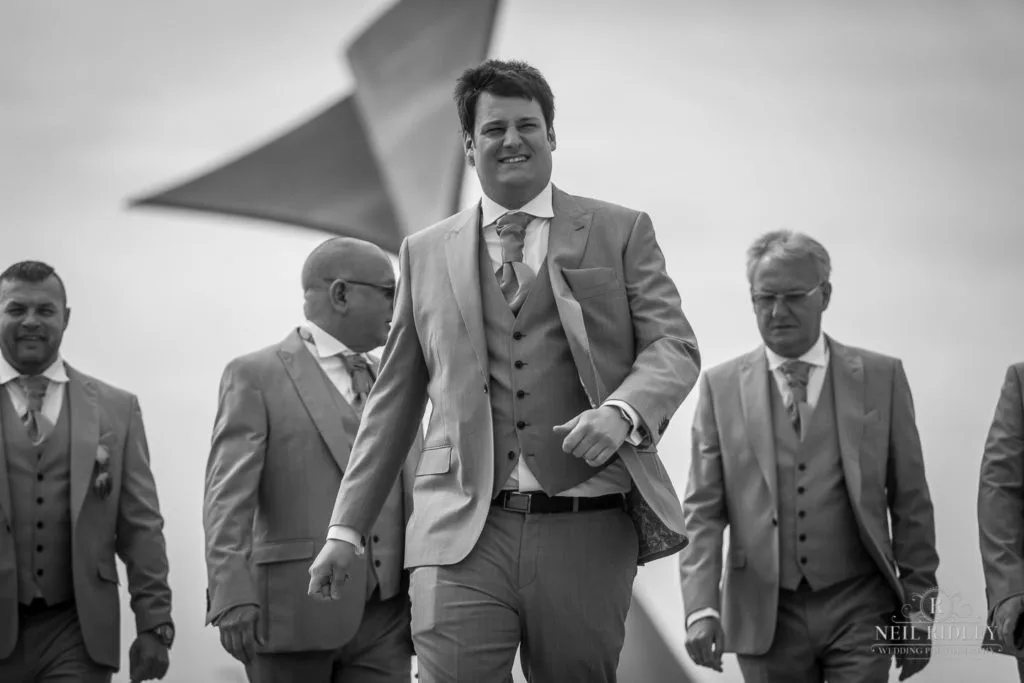 Black and white image of Groom and his party on promenade in Blackpool