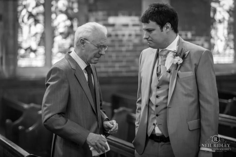 Black and white image of Groom in the church with his Granddad at St Thomas Church in St Annes-on-Sea