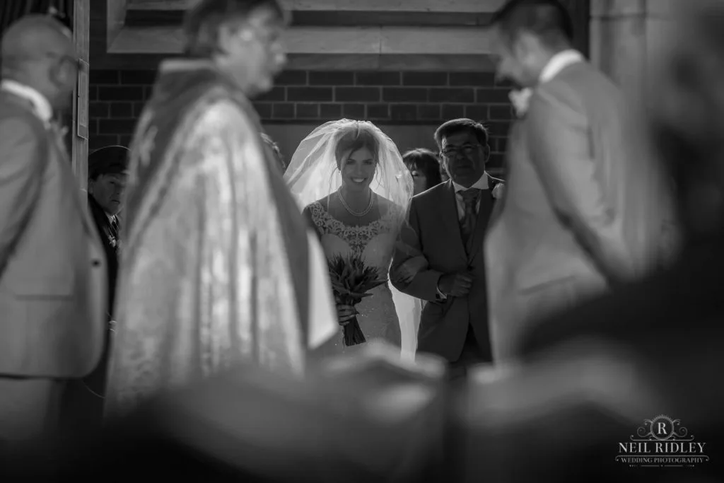 Black and white image of Bride and her Father entering the church at St Thomas Church in St Annes-on-Sea