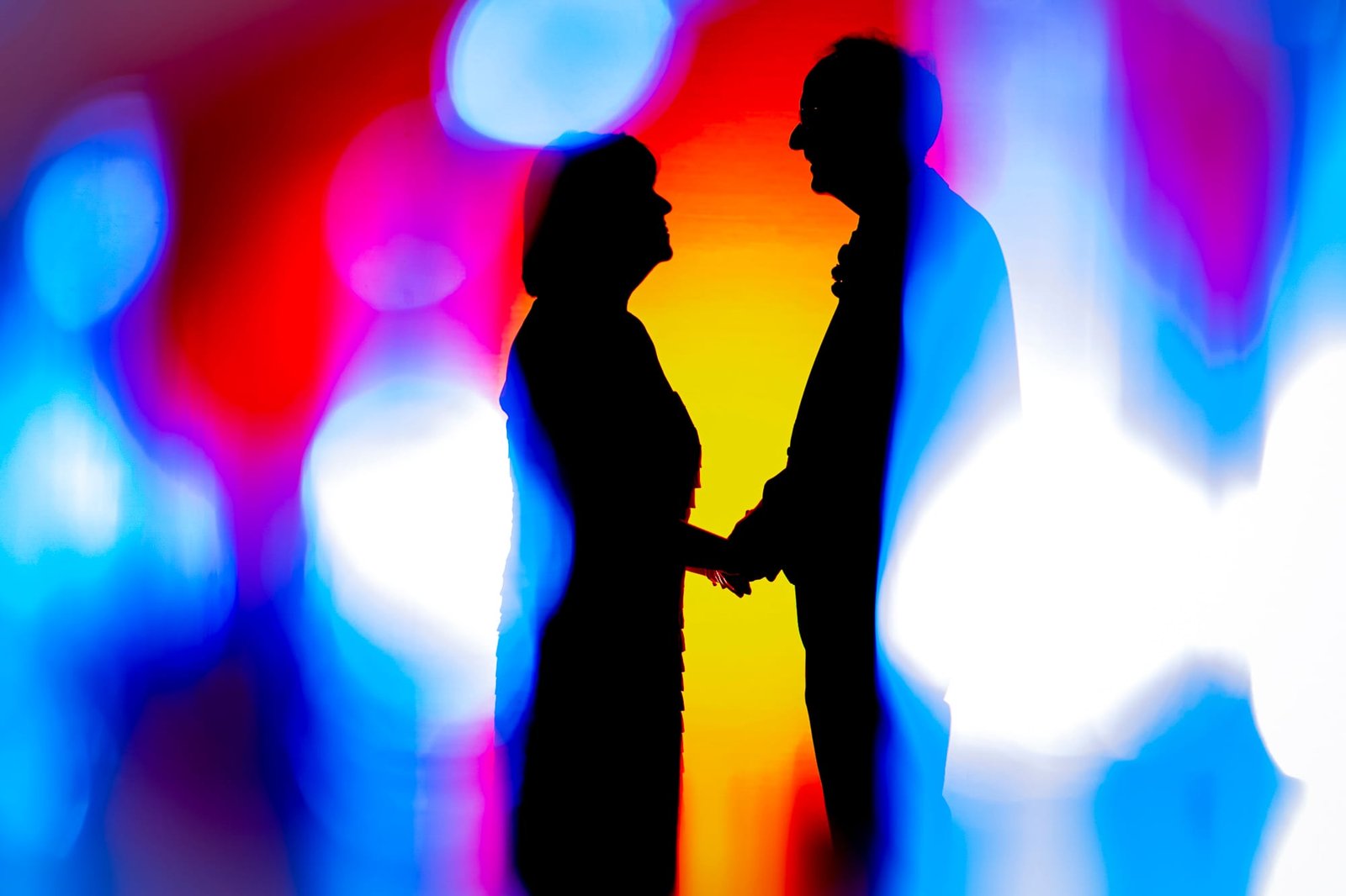 A couple in an artistic and colourful pose