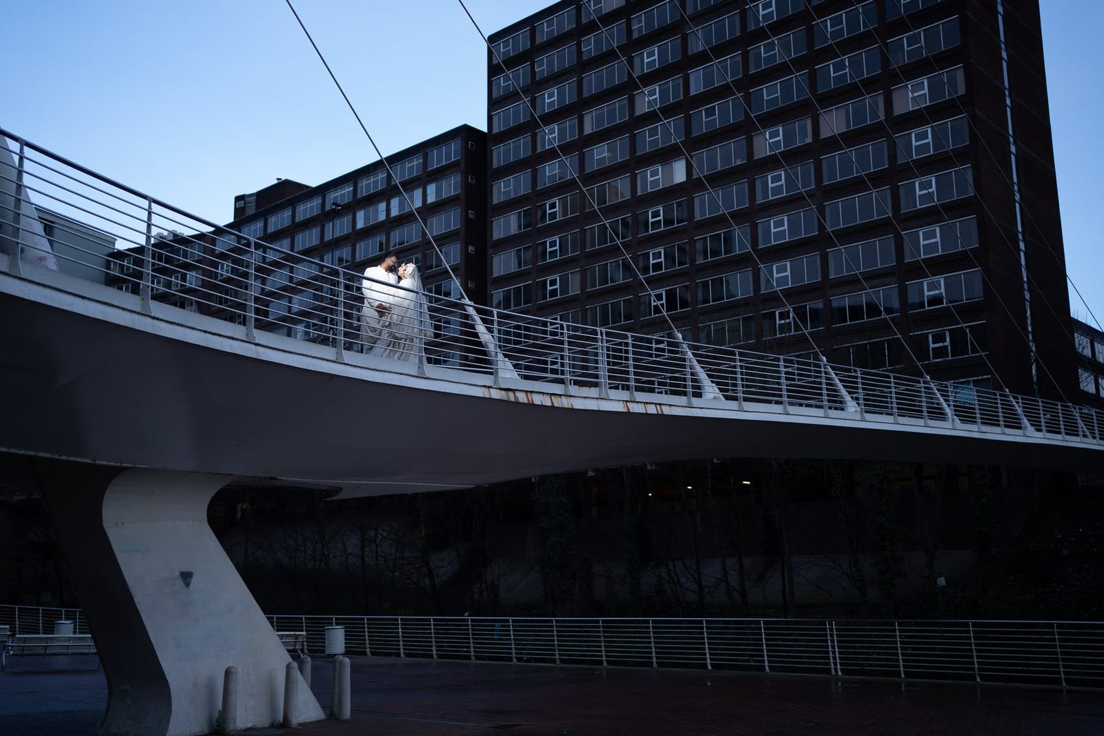 Manchester Wedding couple pose on a bridge